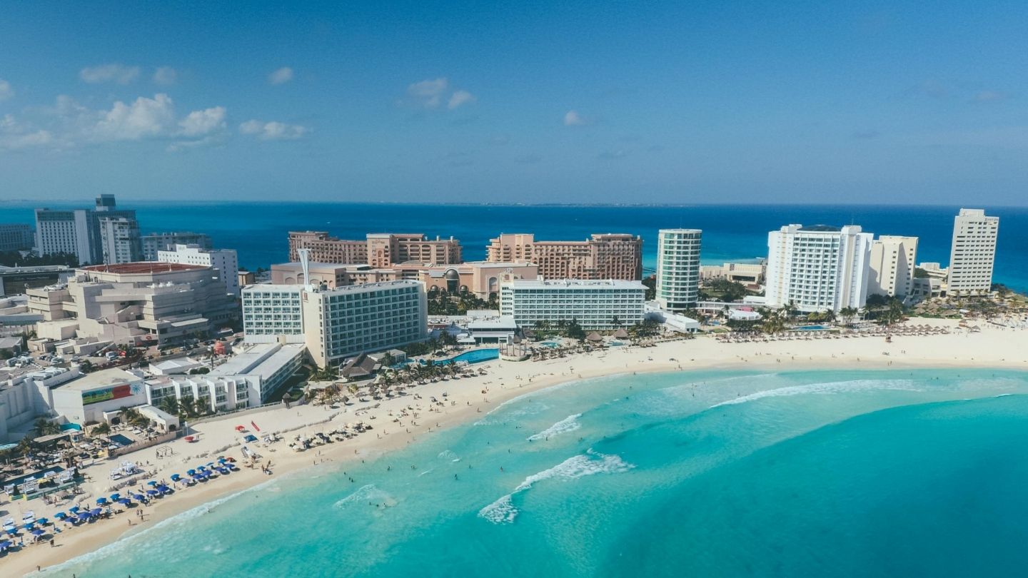Turquoise Caribbean waters and white sand beach along the Cancun coastline