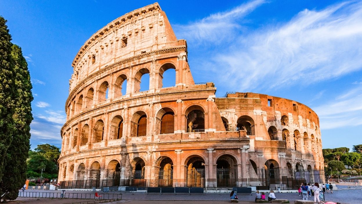 The Colosseum in Rome at golden hour with warm evening light