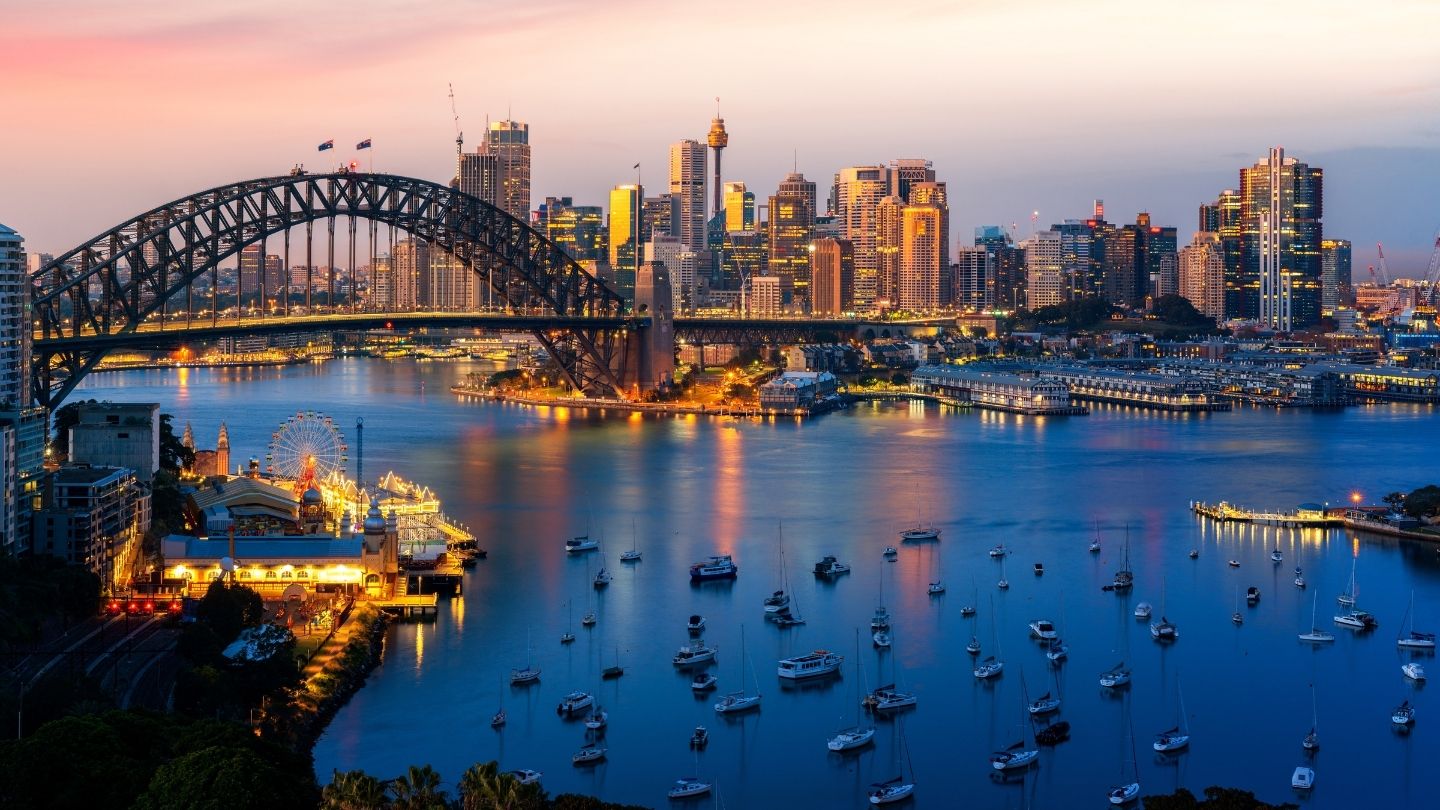 Sydney Opera House and Harbour Bridge at sunset over Sydney Harbour